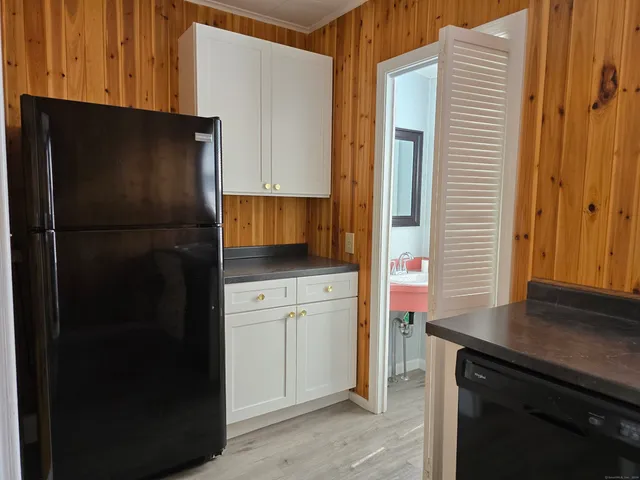 a kitchen with a refrigerator and cabinets