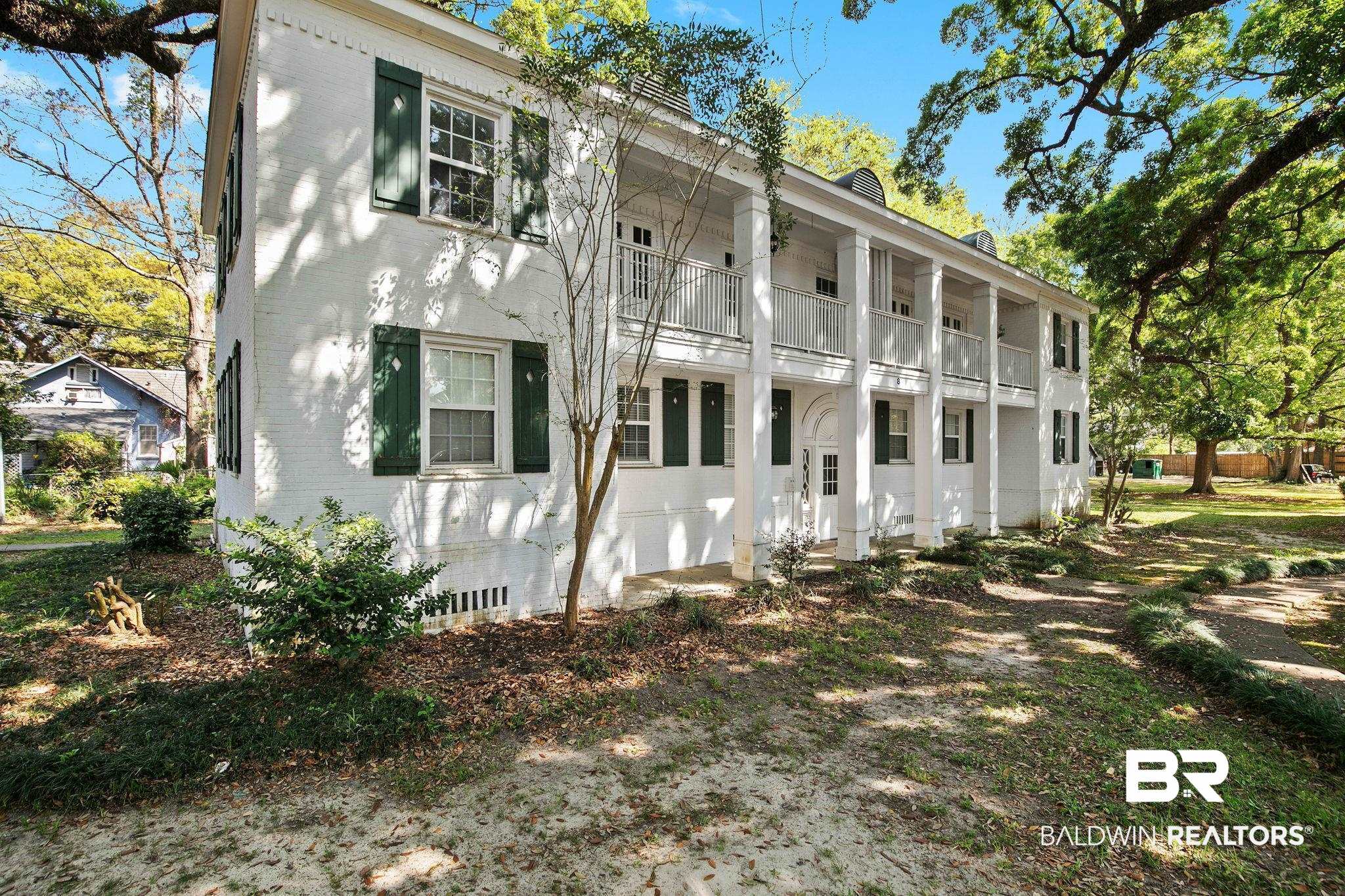 214 Upham Street, Unit 8D Mobile, AL 36607 - Photo 28 of 36 Greek revival house with brick siding, a balcony, and a chimney