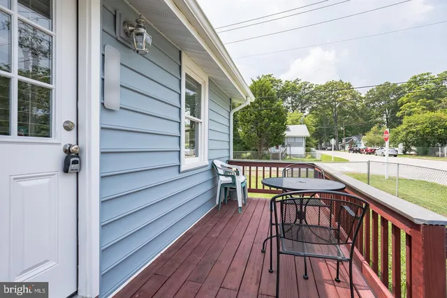 a balcony with wooden floor and outdoor seating