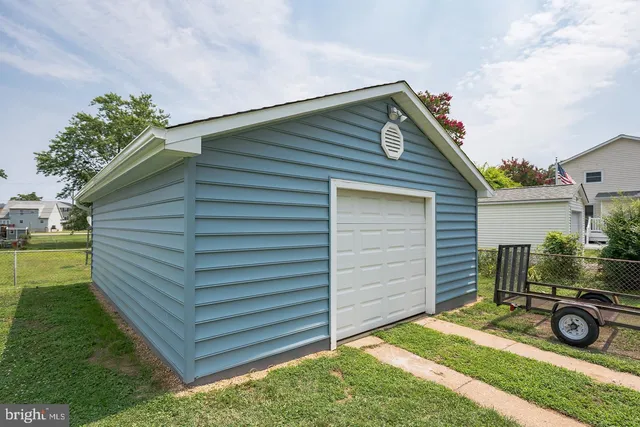 a view of backyard of house and car parked