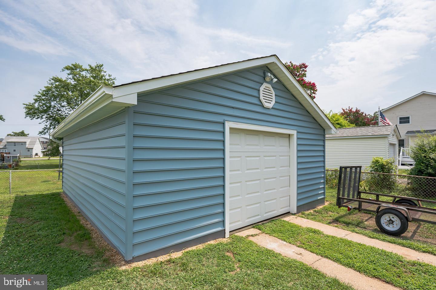 4101 9th Street North Beach, MD 20714 - Photo 3 of 19 a view of backyard of house and car parked