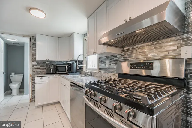 a kitchen with stove and cabinets