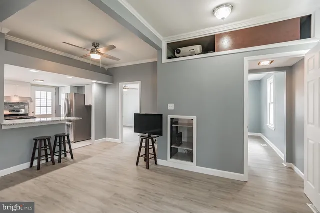 a view of a livingroom with furniture and a kitchen