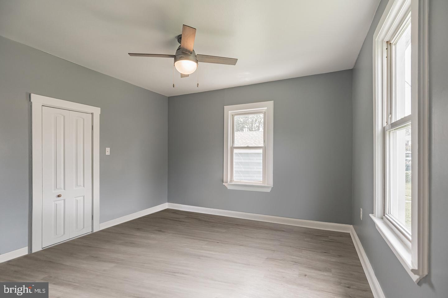 4101 9th Street North Beach, MD 20714 - Photo 10 of 19 a view of empty room with wooden floor and fan