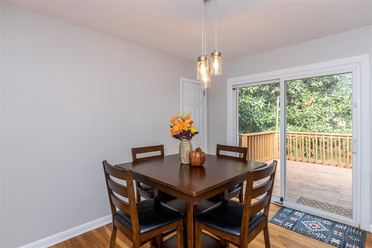 103 Crest Road Cary, NC 27513 - Photo 12 of 30 Great view of deck from dining table. Newish sliding glass door. Walk-in pantry to left. Dining