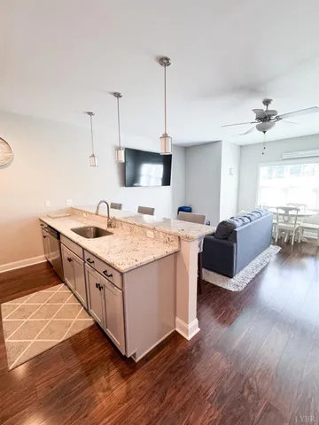 a kitchen with stainless steel appliances granite countertop a stove and a wooden floors