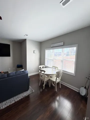 a dining room with furniture and wooden floor