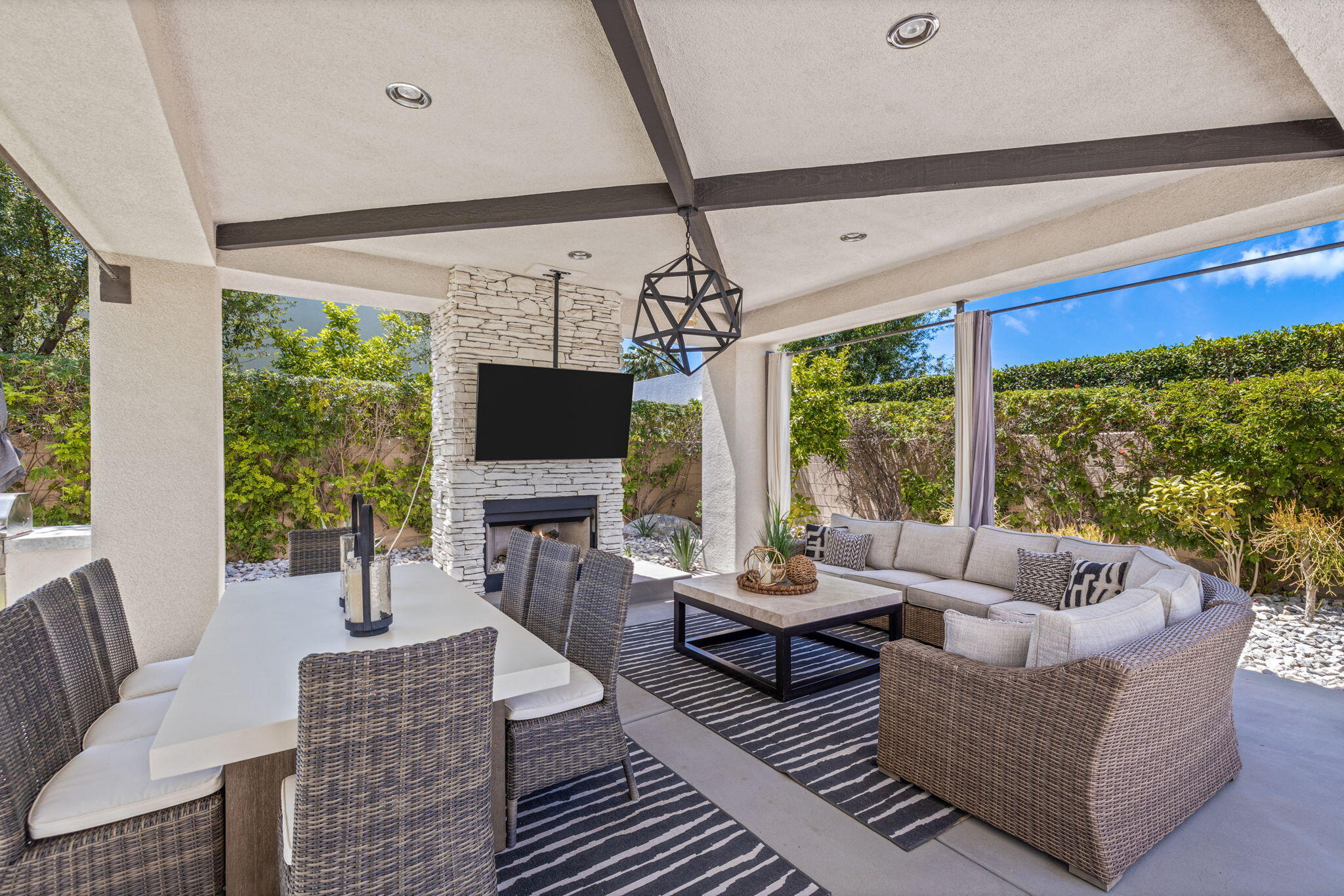 36725 Palm View Road Rancho Mirage, CA 92270 - Photo 117 of 136 a living room with furniture a flat screen tv and a floor to ceiling window