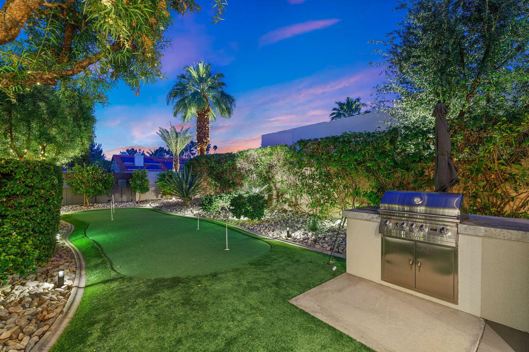 36725 Palm View Road Rancho Mirage, CA 92270 - Photo 15 of 136 a view of a backyard with a table and a chairs