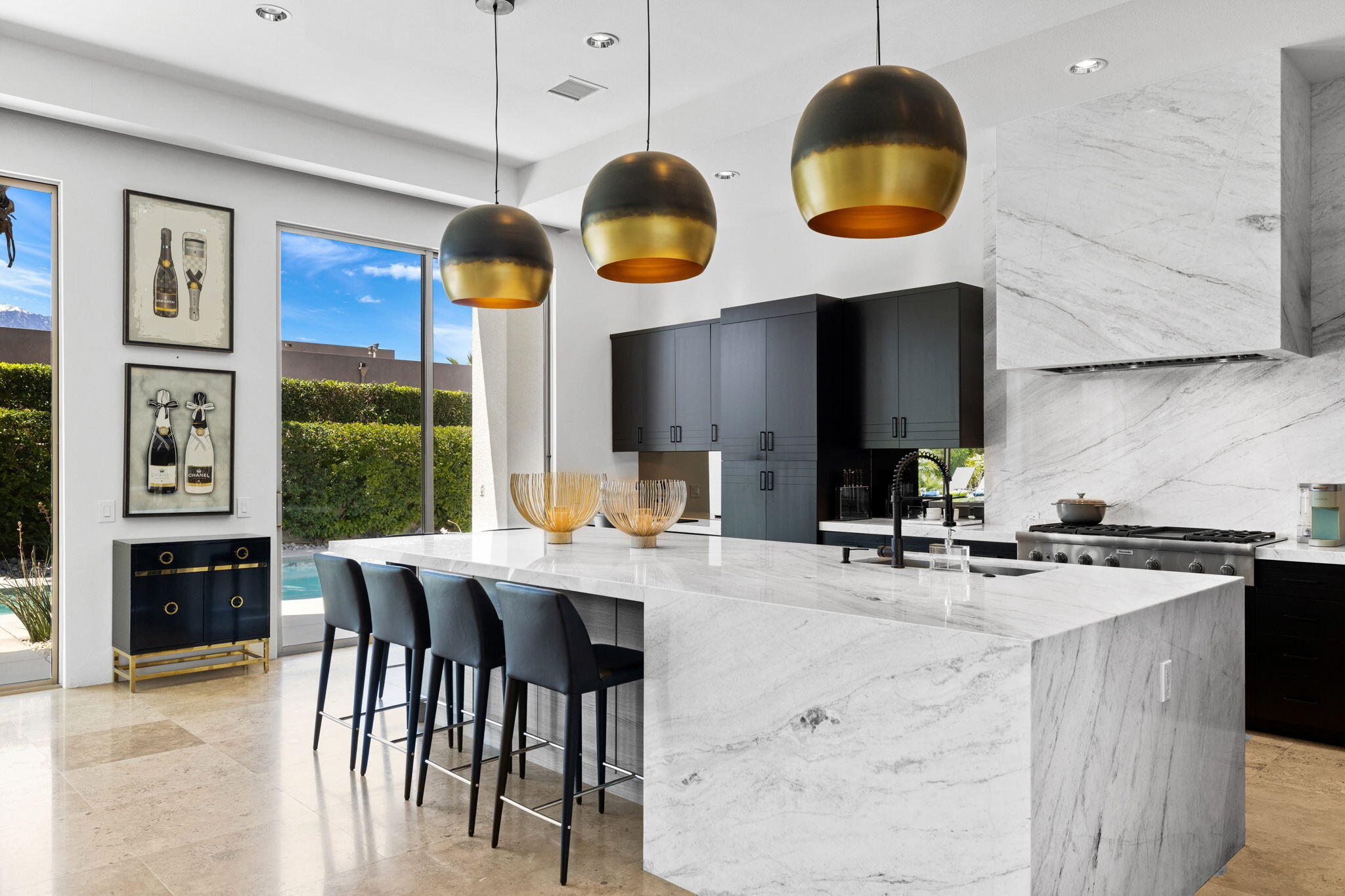 36725 Palm View Road Rancho Mirage, CA 92270 - Photo 57 of 136 a kitchen with stainless steel appliances granite countertop a stove a sink and a dining table with garden view