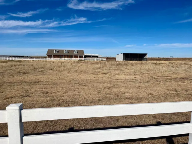 a view of a barn in the middle of a yard