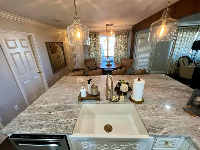 a kitchen with stainless steel appliances a refrigerator sink and microwave