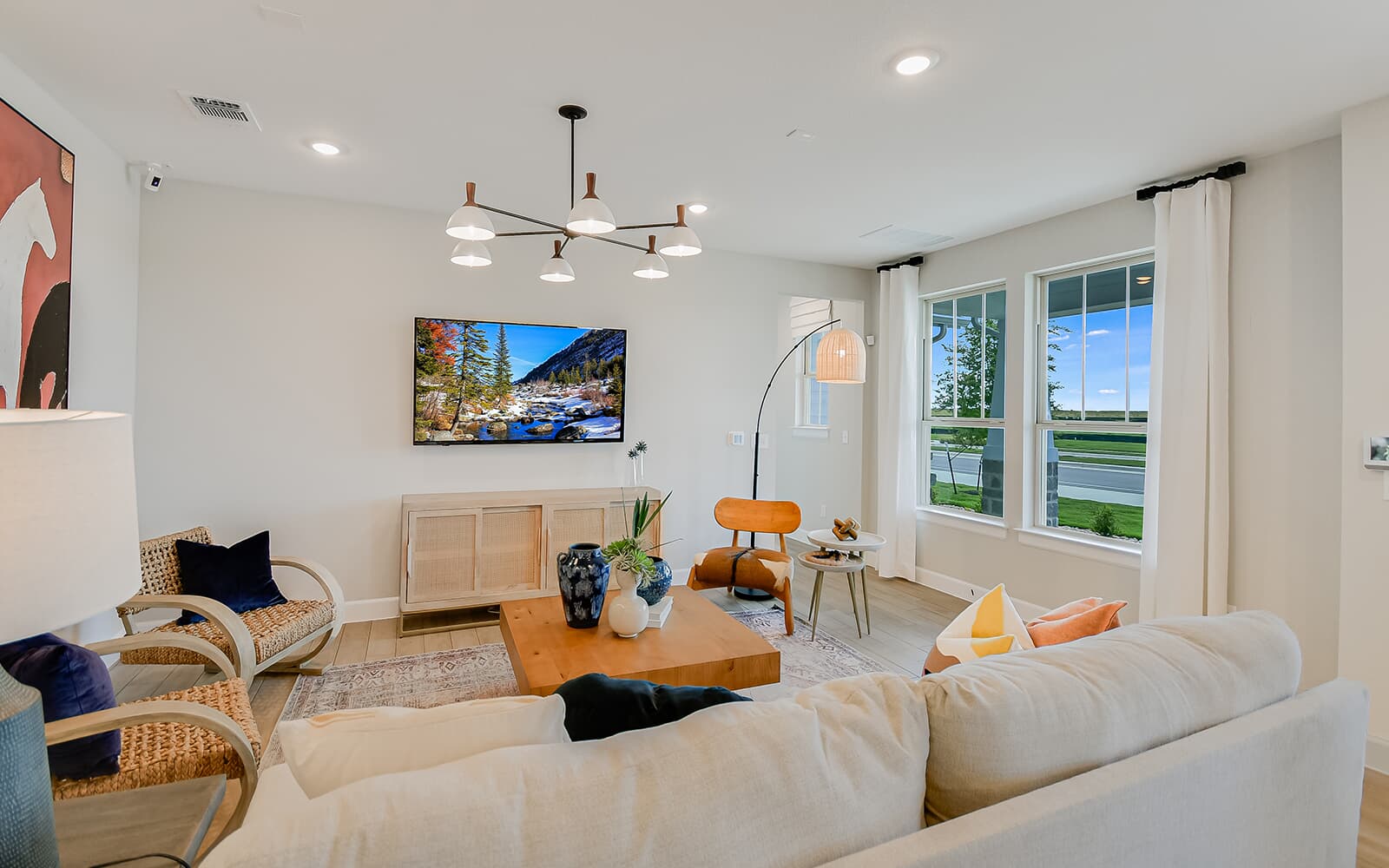 8818 Marmoset Way Austin, TX 78744 - Photo 18 of 19 Living area with suspended lighting and light wood finished floors