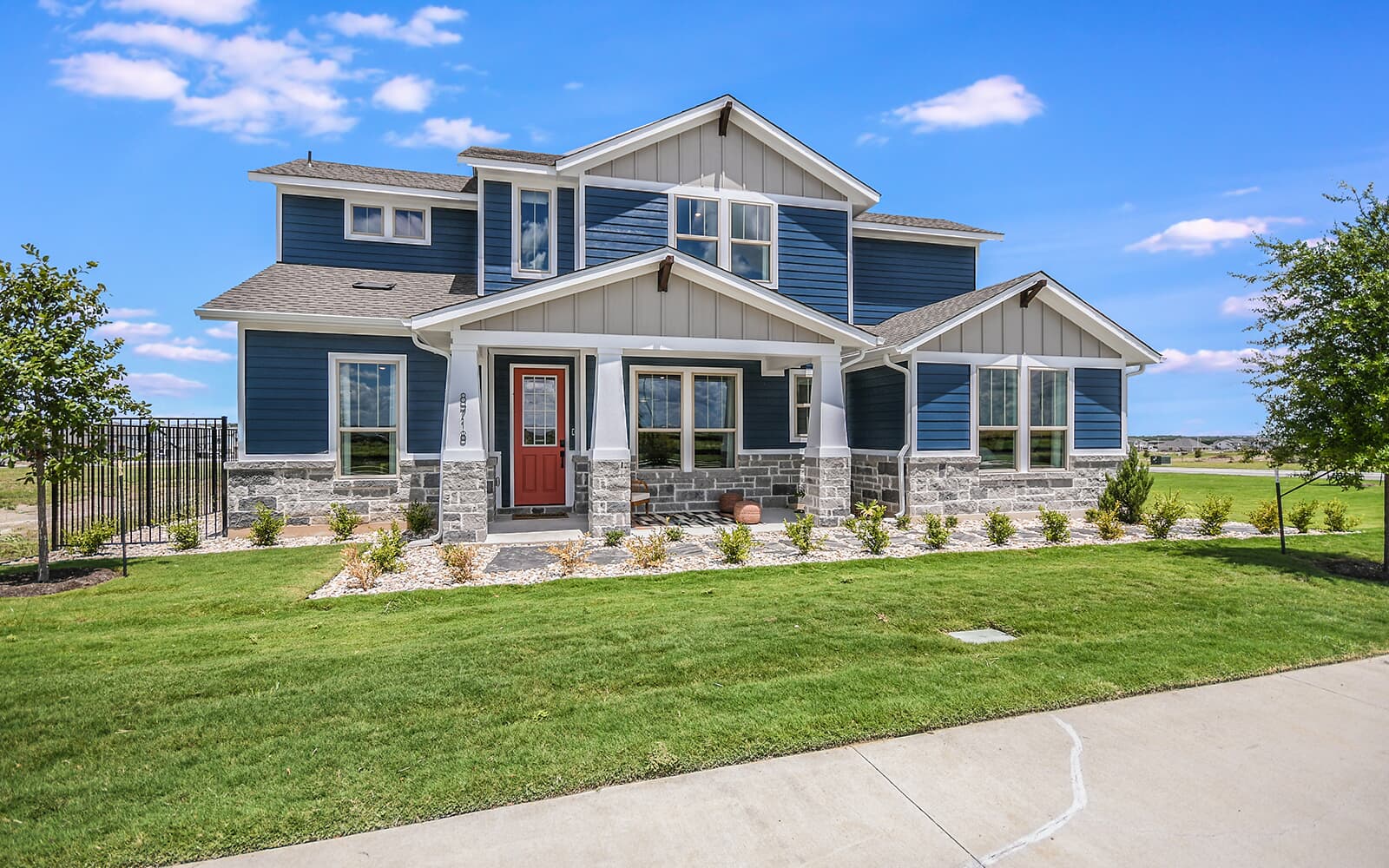 8818 Marmoset Way Austin, TX 78744 - Photo 2 of 19 Craftsman inspired home with a porch, stone siding, board and batten siding, and a shingled roof