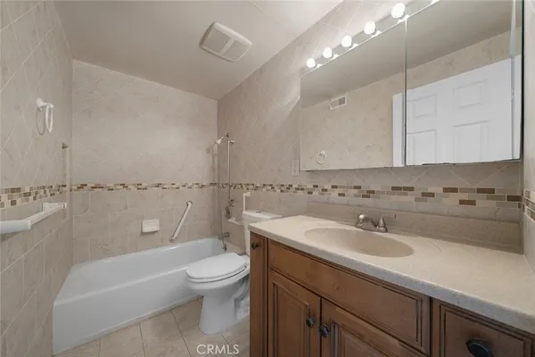 a bathroom with a sink a toilet and bathtub