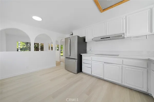 a kitchen with refrigerator and cabinets