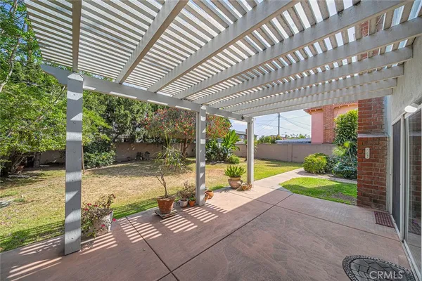a view of swimming pool with garden and patio
