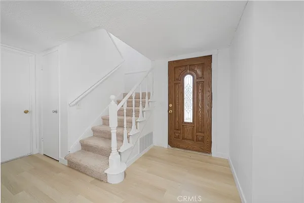 a view of entryway and hall with a front door