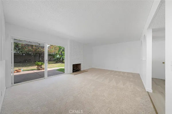 an empty room with floor to ceiling windows and an outdoor view