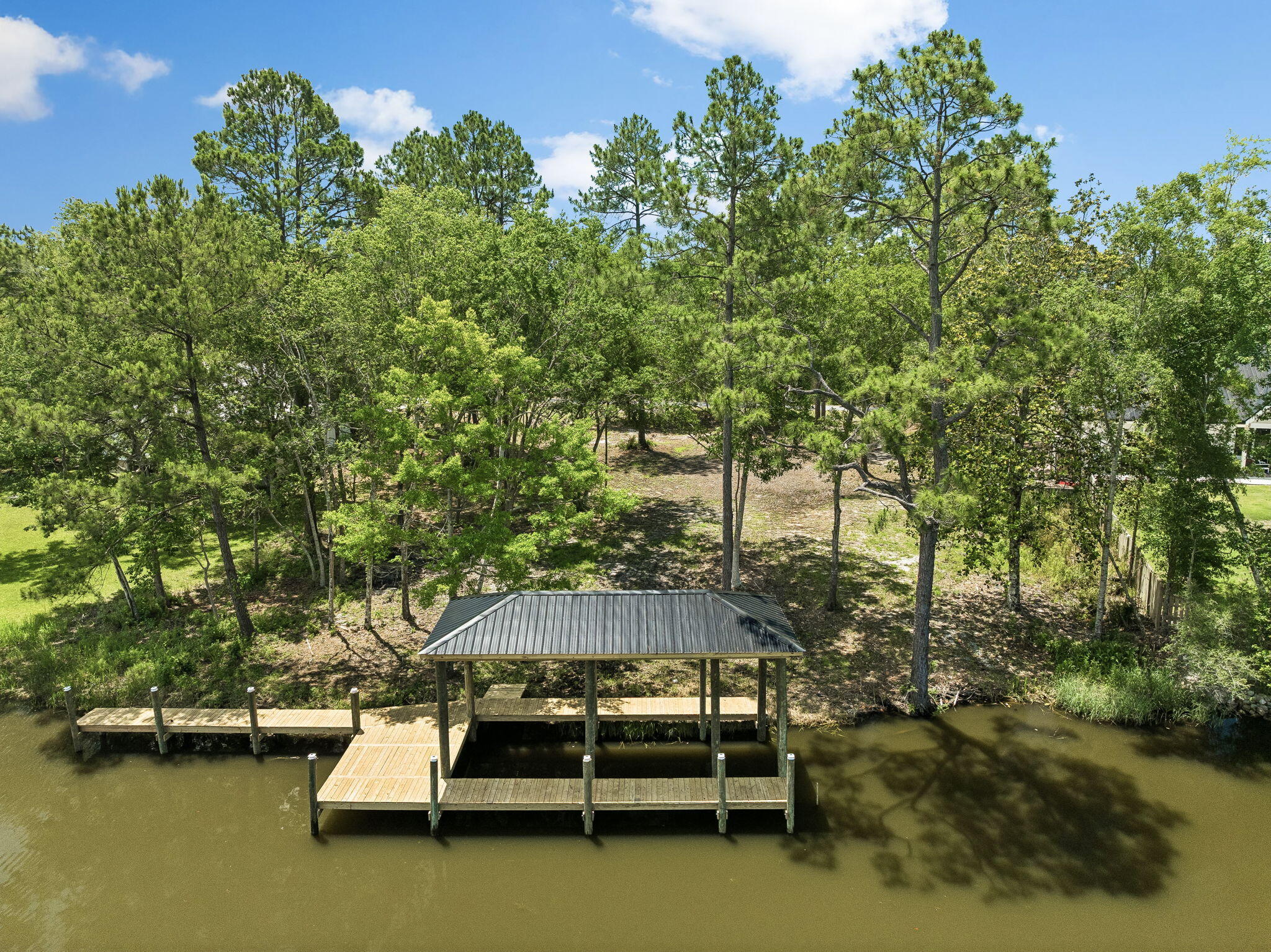 92 Waterside Lane Freeport, FL 32439 - Photo 12 of 28 a backyard of a house with outdoor seating and lake view