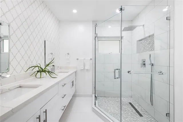 a bathroom with a shower sink and mirror
