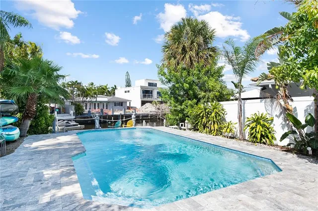 a view of a backyard with plants and a patio