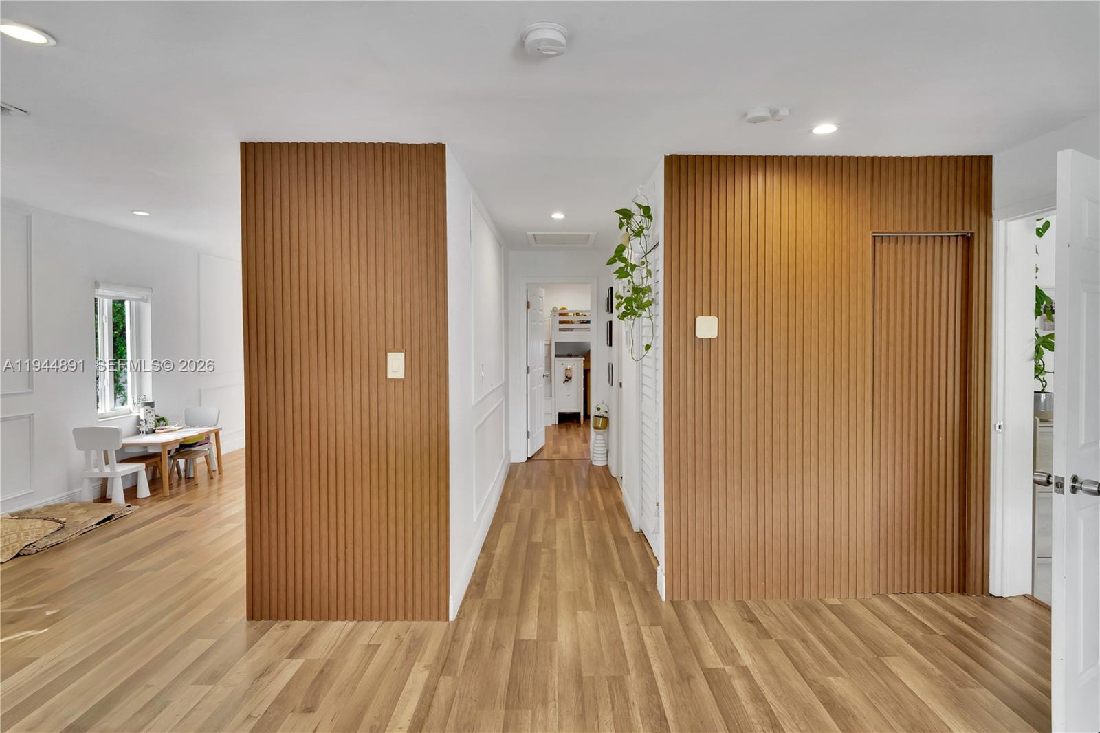 1450 Southwest 20th Avenue Miami, FL 33145 - Photo 12 of 44 a view of a hallway with wooden floor and dining room