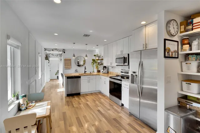 a large kitchen with stainless steel appliances lots of counter space and breakfast area