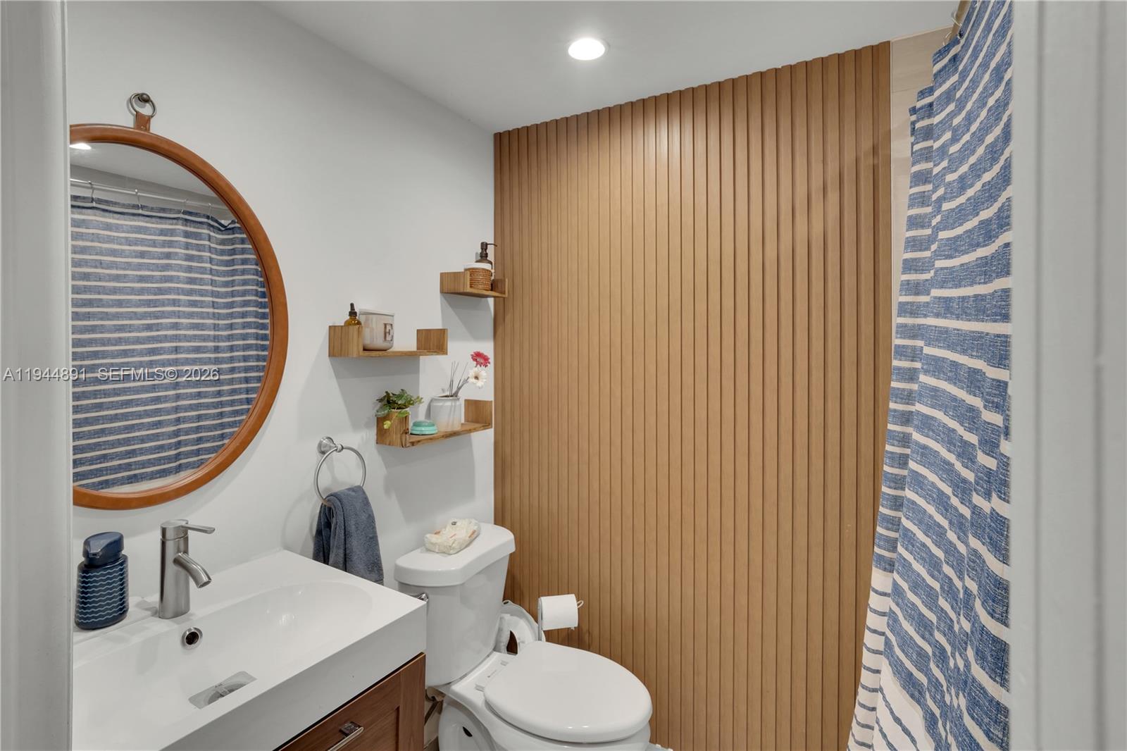 1450 Southwest 20th Avenue Miami, FL 33145 - Photo 26 of 44 a bathroom with a sink a toilet and a mirror