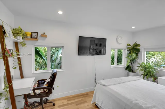 a bedroom with furniture and a window