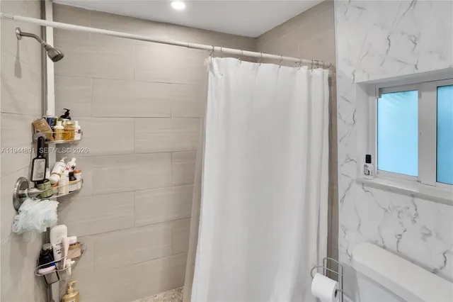 a bathroom with a shower and a tub