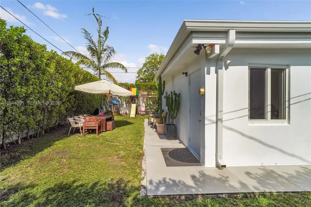 a view of a house with backyard porch and sitting area