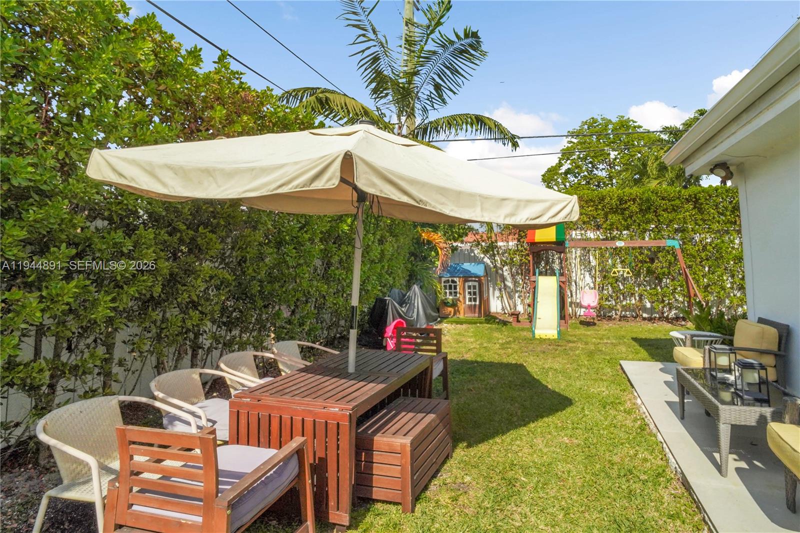 1450 Southwest 20th Avenue Miami, FL 33145 - Photo 39 of 44 a view of a patio with table and chairs under an umbrella