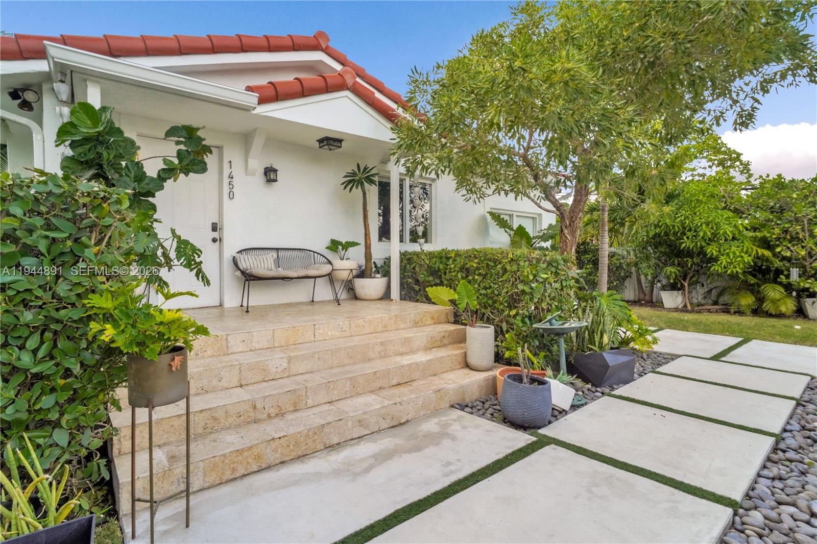 1450 Southwest 20th Avenue Miami, FL 33145 - Photo 6 of 44 a view of a patio with table and chairs potted plants and a large tree