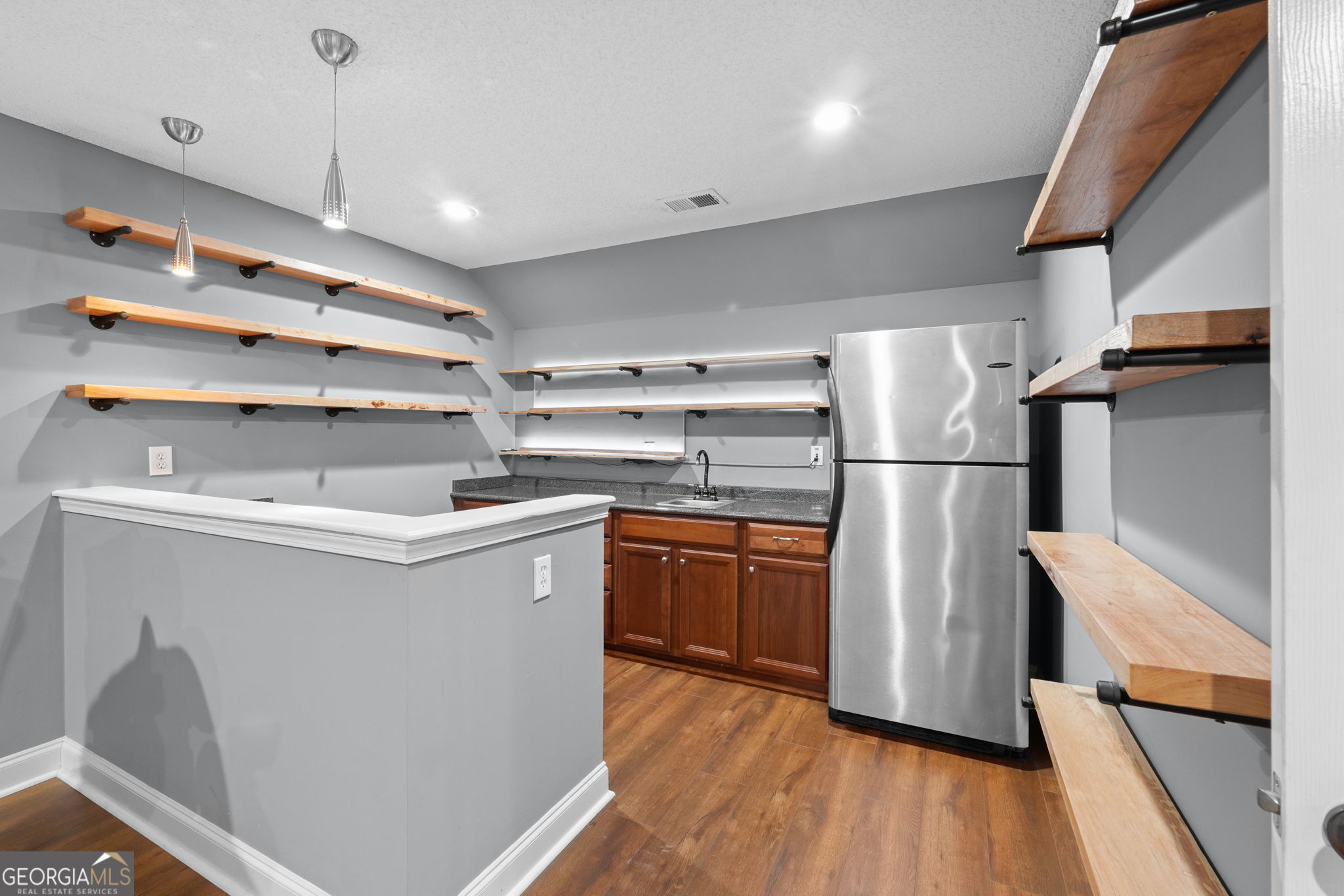 330 James Moore Circle Jackson, GA 30233 - Photo 21 of 31 a kitchen with refrigerator and cabinets