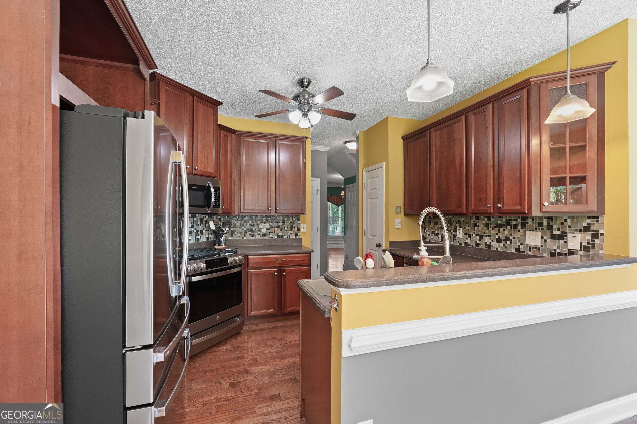 330 James Moore Circle Jackson, GA 30233 - Photo 5 of 31 a kitchen with stainless steel appliances granite countertop a sink a stove and a refrigerator