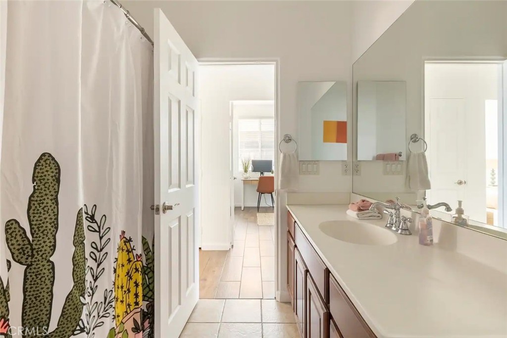 50157 Calle Tolosa Coachella, CA 92236 - Photo 14 of 24 a bathroom with a sink a mirror and a shower