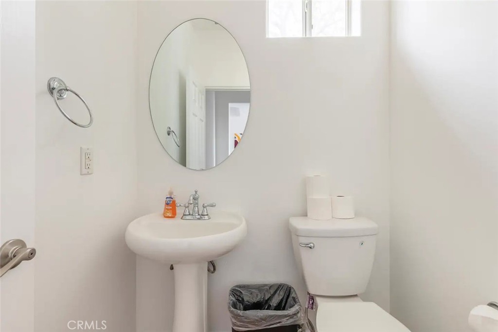 50157 Calle Tolosa Coachella, CA 92236 - Photo 16 of 24 a bathroom with a toilet sink and mirror