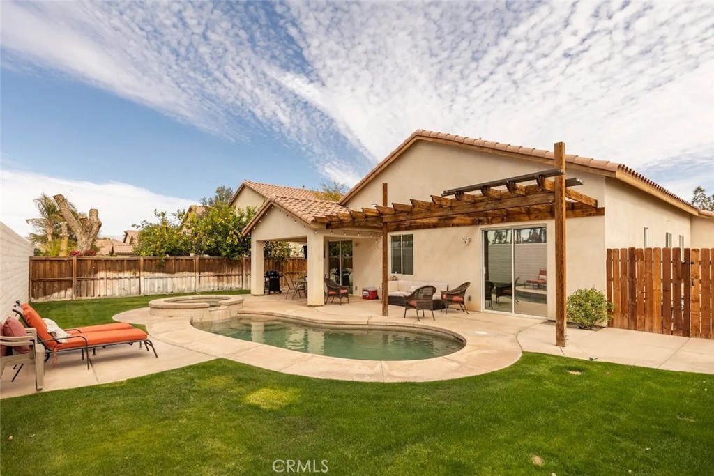 50157 Calle Tolosa Coachella, CA 92236 - Photo 18 of 24 a view of a house with swimming pool and a yard