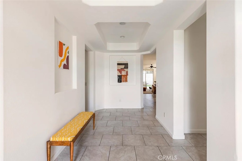 50157 Calle Tolosa Coachella, CA 92236 - Photo 7 of 24 a view of a hallway with wooden floor and a bathroom