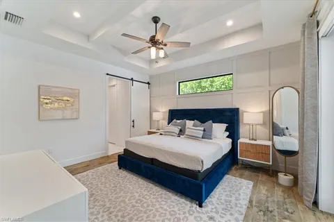 a bedroom with a large bed and a chandelier