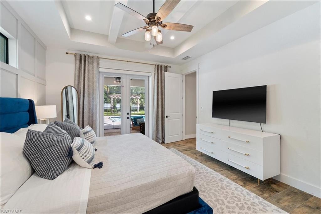 3554 McComb Lane Bonita Springs, FL 34134 - Photo 12 of 25 a spacious bedroom with a bed and a flat screen tv