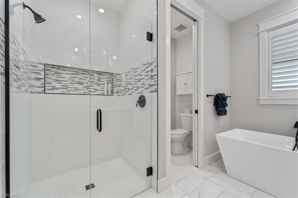 3554 McComb Lane Bonita Springs, FL 34134 - Photo 14 of 25 a bathroom with a shower a toilet and a shower