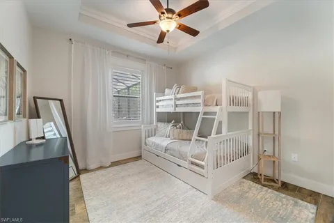 a white bed sitting in a room next to a window