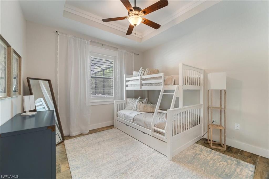 3554 McComb Lane Bonita Springs, FL 34134 - Photo 16 of 25 a white bed sitting in a room next to a window