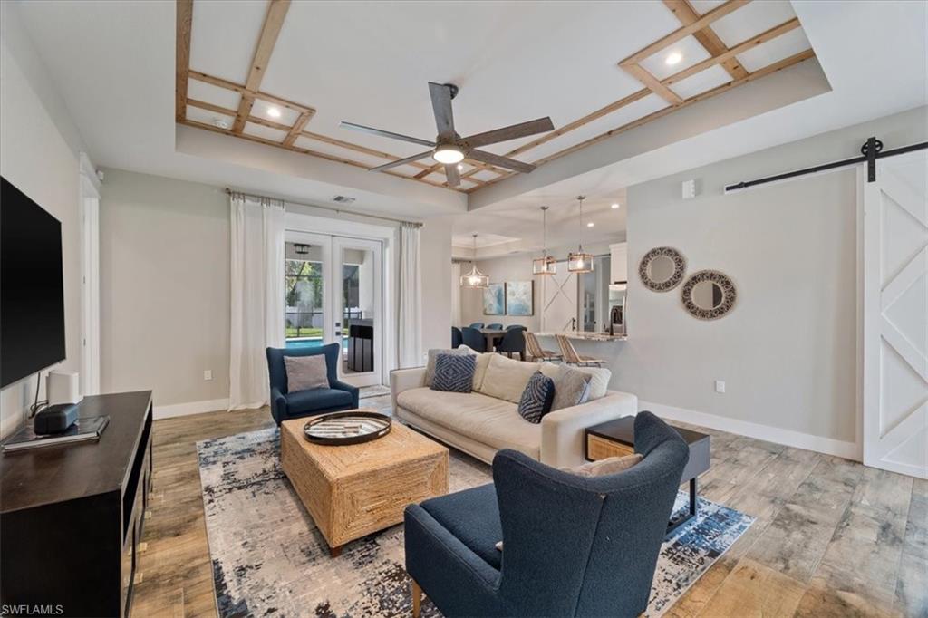 3554 McComb Lane Bonita Springs, FL 34134 - Photo 2 of 25 a living room with furniture a ceiling fan and a rug