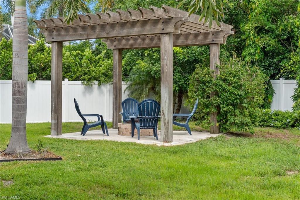 3554 McComb Lane Bonita Springs, FL 34134 - Photo 22 of 25 a view of a house with a backyard and a slide