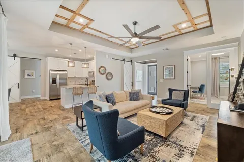 a living room with furniture appliances and a chandelier