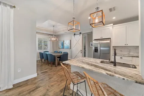 a kitchen with stainless steel appliances kitchen island a refrigerator and a stove