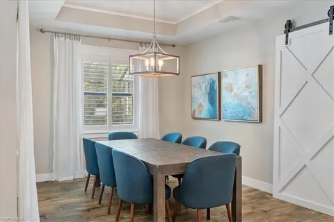 a view of a dining room with furniture wooden floor and chandelier
